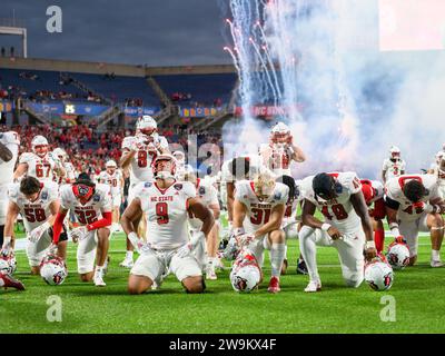 Orlando, FL, USA. 28th Dec, 2023. NC State players kneel in prayer before first half of the Pop Tarts Bowl in Orlando, FL. Romeo T Guzman/Cal Sport Media/Alamy Live News Stock Photo