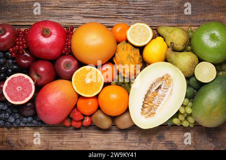 Many different fresh fruits and berries on wooden table, flat lay Stock Photo