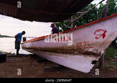 Cabimas, Venezuela. 28th Dec, 2023. A fisherman is seeing getting his boat ready before going out fishing. After being exploited for intense oil extraction for decades, Lake Maracaibo has become heavily polluted due to the neglect and lack of maintainance of the old pipes and infrastructure. This has caused a severe decline in fish stock, with the appearance of bacterias and toxic algae on the water surface, damaging the lives of the people living on its shores who rely on fishing for a living. Credit: SOPA Images Limited/Alamy Live News Stock Photo