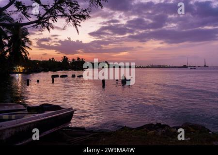 Cabimas, Venezuela. 28th Dec, 2023. Fishing boats are seen on the shore of Lake Maracaibo at sunrise. After being exploited for intense oil extraction for decades, Lake Maracaibo has become heavily polluted due to the neglect and lack of maintainance of the old pipes and infrastructure. This has caused a severe decline in fish stock, with the appearance of bacterias and toxic algae on the water surface, damaging the lives of the people living on its shores who rely on fishing for a living. Credit: SOPA Images Limited/Alamy Live News Stock Photo