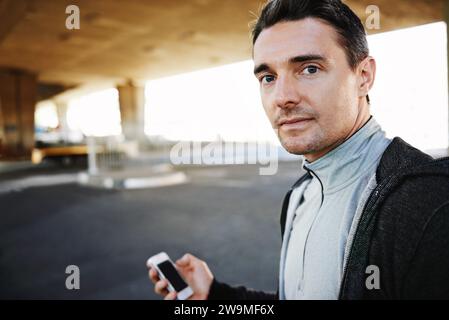 Man, portrait and checking fitness progress in outdoors, screen and exercise or training for marathon. Male person, athlete and workout by city Stock Photo
