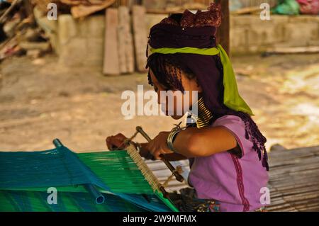 Karen Long Neck Girl At Work, Hill-Tribe Village, Northern Thailand Stock Photo