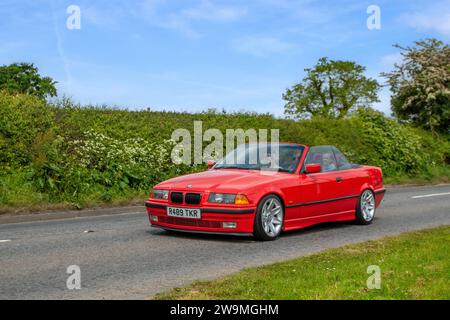 1998 90s nineties Red BMW 323I Auto saloon Car Petrol 2494 cc, 2.5 L 2-door convertible; Vintage restored classic specialist motors vehicle restoration, automobile collectors, yesteryear motoring enthusiasts and historic veteran cars travelling in Cheshire, UK Stock Photo