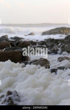 Freshwater Bay, Totland. 28th December 2023. Storm force winds from Storm Gerrit hit the Isle of Wight yesterday and overnight. Large waves, high gusts of wind and sea foams were some of the hazards that continued today at the beach. Credit: james jagger/Alamy Live News Stock Photo