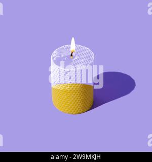 Creative layout of beeswax candle made with natural wax produced by honey bees on pastel violet background. Minimal concept. Trendy candle idea. Stock Photo