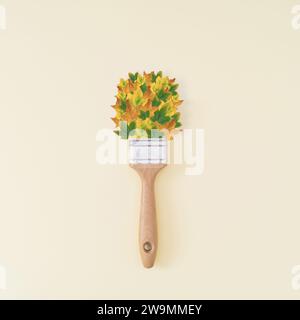 Creative autumn layout made of brush and colorful fallen leaves on pastel background. Season concept. Minimal autumn or fall idea. Autumn aesthetic. Stock Photo