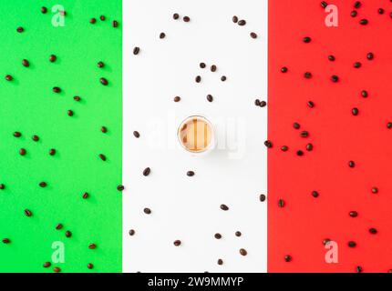 Creative layout made of cup of coffee and coffee beans on flag of Italy as a background. Minimal coffee concept. Trendy espresso idea. Flat lay Stock Photo