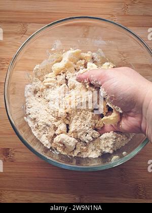 Overhead view of a woman mixing cookie dough in a glass bowl Stock Photo