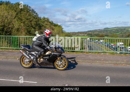 Motorcycle animal backpack. Cartoon knapsack bag on rider crossing motorway bridge in Manchester, UK Stock Photo