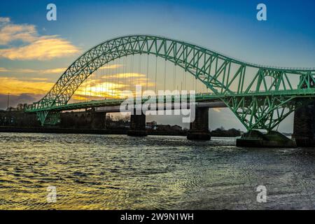 Sunset over the Queensway Jubilee bridge over the river Mersey between Widnes and Runcorn in Halton. Stock Photo