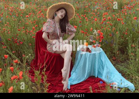 A young girl in a flowering poppy field Stock Photo