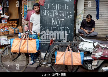 In a narrow lane in Dongri, Mumbai, India, a signboard forbids non-residents to park their bikes, space for cars being non-existent anyway Stock Photo