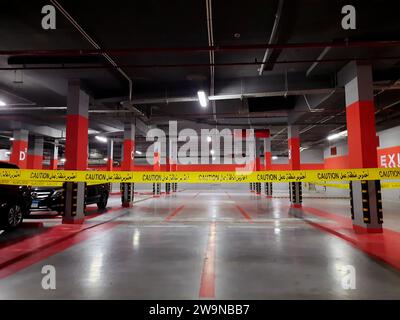 Cairo, Egypt, November 24 2023: a maintenance area zone with a yellow ribbon, an area zone in an underground garage for vehicles parking with a locked Stock Photo