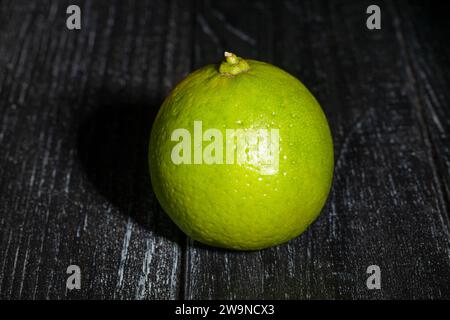 one limes on wood background Stock Photo
