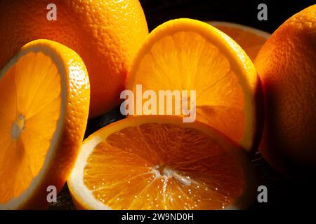 sliced orange fruit on black background Stock Photo