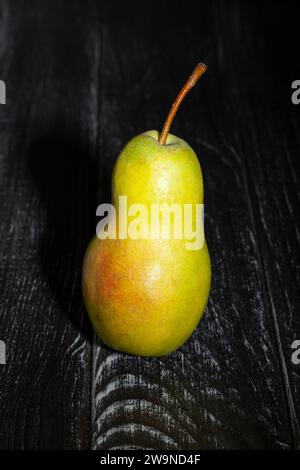 single pear on wood background Stock Photo