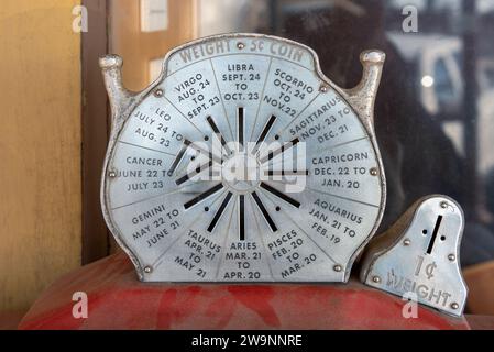 Vintage penny scale vending machine that gives weight and horoscope. Stock Photo