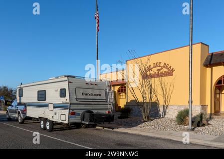 Dutchman travel trailer pulled by a pickup parked in front of the Judge Roy Bean Travel Center, Langtry, Texas, USA. Stock Photo