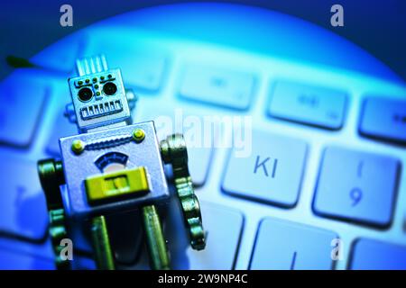 Robot Figure Lies On A Computer Keyboard, Symbol Photo Artificial Intelligence, Photomontage Stock Photo