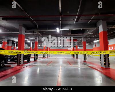 Cairo, Egypt, November 24 2023: a maintenance area zone with a yellow ribbon, an area zone in an underground garage for vehicles parking with a locked Stock Photo