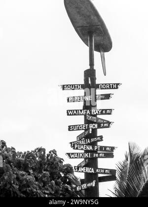 Wooden travel direction signs near a beach bar on the Perhentian islands in Malaysia in black and white Stock Photo