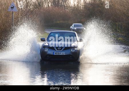 A  car seen drinving through floodwater at Fairburn Ings in North Yorkshire,UK Stock Photo