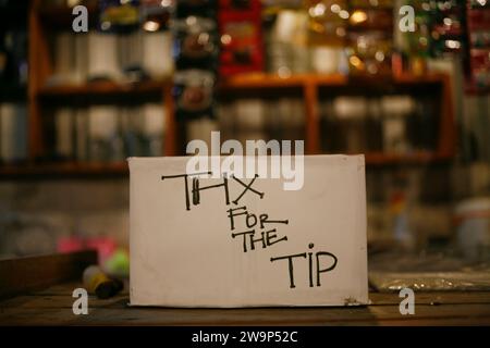 White box with words of thank for the tip in table Stock Photo