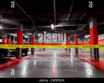 Cairo, Egypt, November 24 2023: a maintenance area zone with a yellow ribbon, an area zone in an underground garage for vehicles parking with a locked Stock Photo