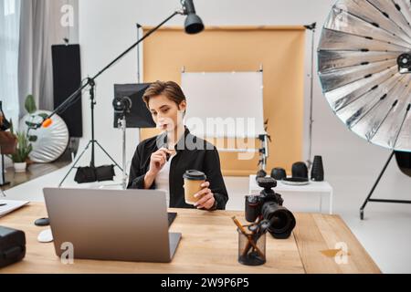 gorgeous professional female designer in casual attire working with her drawing tablet in studio Stock Photo