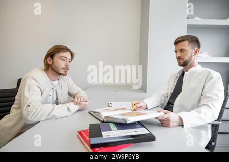 Vascular surgeon during a consultation with patient Stock Photo