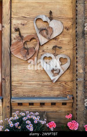 Heart shape decos hanging on a rustic wooden door Stock Photo