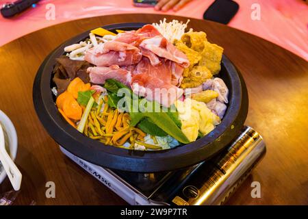 Alishan, Taiwan - October 08 2023 : Delicious Taiwanese Hot Pot in a Chinese Restaurant with Pork and various Vegetables Stock Photo