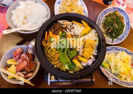 Alishan, Taiwan - October 08 2023 : Delicious Taiwanese Hot Pot in a Chinese Restaurant with Pork and various Vegetables Stock Photo