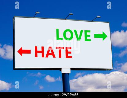 Love or hate symbol. Concept word Love or Hate on beautiful billboard with two arrows. Beautiful blue sky with clouds background. Business and love or Stock Photo