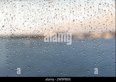 Raindrops on a window pane. Background of raindrops. Stock Photo