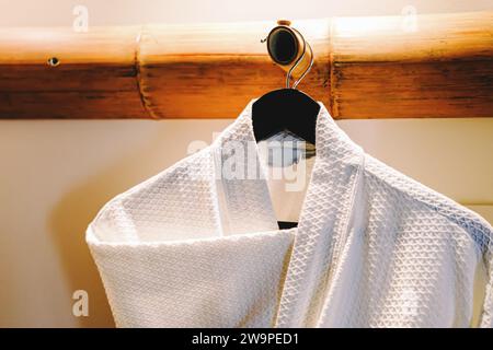 Cozy waffle cotton bathrobe on the hanger close-up Stock Photo