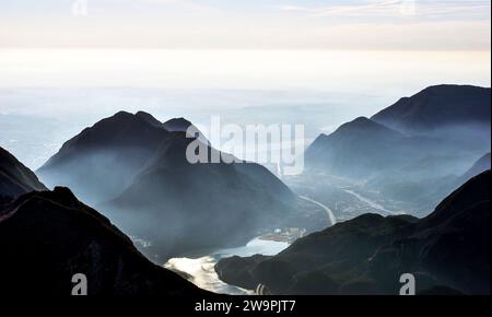 Beautiful panorama and view from the top of the Amariana mountain in Friuli Venezia Giulia. View of Lake Cavazzo and other nearby mountains. Foggy day Stock Photo