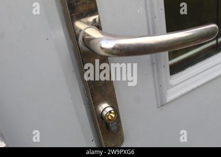 A close up photo of a locking mechanism, door handle on the front door of a house. Stock Photo