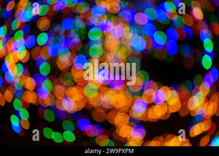 Large vibrant green, red, orange and blue bokeh balls swirling and creating magical ornament. Abstract background. Real photo. Stock Photo