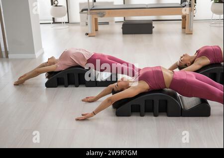 Balanced Body Pilates Arc. Three asian women exercising on pilates arc. by  mrwed54 Vectors & Illustrations with Unlimited Downloads - Yayimages