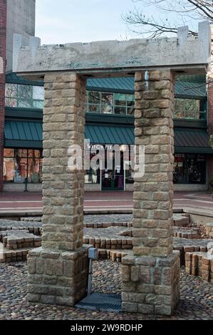 Salem, Massachusetts - A shop with a sign reading Witch Pix is framed by an Asian brick structure in a drained fountain. Stock Photo