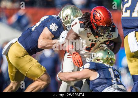 El Paso, Texas, USA. 29th Dec, 2023. Oregon State Beavers running back Deshaun Fenwick (1) is tackled by Notre Dame Fighting Irish linebacker Jack Kiser (24) and defensive lineman Jordan Botelho (12) during the NCAA football game in the 90th annual Tony the Tiger Sun Bowl between the Oregon State Beavers and the Notre Dame Fighting Irish at Sun Bowl Stadium in El Paso, Texas. Notre Dame defeated Oregon State 40-8. Prentice C. James/CSM (Credit Image: © Prentice C. James/Cal Sport Media). Credit: csm/Alamy Live News Stock Photo