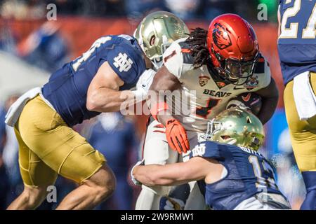 El Paso, Texas, USA. 29th Dec, 2023. Oregon State Beavers running back Deshaun Fenwick (1) is tackled by Notre Dame Fighting Irish linebacker Jack Kiser (24) and defensive lineman Jordan Botelho (12) during the NCAA football game in the 90th annual Tony the Tiger Sun Bowl between the Oregon State Beavers and the Notre Dame Fighting Irish at Sun Bowl Stadium in El Paso, Texas. Notre Dame defeated Oregon State 40-8. Prentice C. James/CSM/Alamy Live News Stock Photo