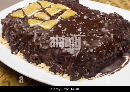 Close-up of the hazelnut base of a cocoa and chocolate cake on a plate. Homemade desserts. Stock Photo