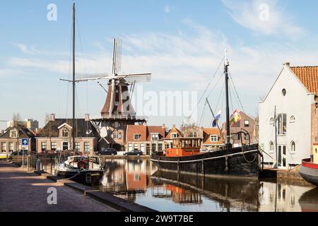 Windmill along the canal in the center of the city of Meppel. Stock Photo