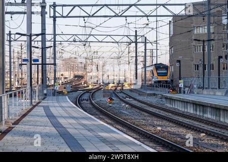 Train tracks and overhead power cables near the central station of the Dutch city of Utrecht. Stock Photo