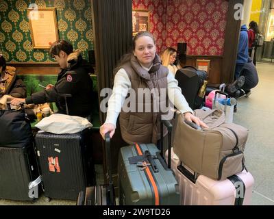 Tourist Nicole Carrera, 29, who is visiting the UK from New York with her husband Christopher, waits at St Pancras International station, central London, after their Eurostar train to Paris was cancelled, ruining their plans to spend New Year's Eve at Disneyland Paris. Eurostar services between London and Ebbsfleet have been cancelled because of flooding in a tunnel under the Thames. Picture date: Saturday December 30, 2023. Stock Photo