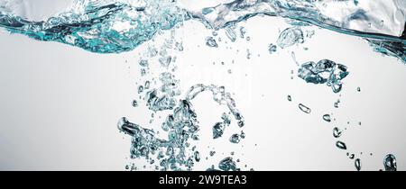 Blue water background with splashes, waves and underwater air bubbles. Stock Photo