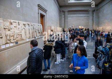 London, UK. 30th Dec, 2023. Visitors at the British Museum view ancient sculptures in the Parthenon Galleries. They are also referred to as The Elgin Marbles after Lord Elgin took them to London between 1801 and 1812. Tony Blair considered loaning them to Greece as an idea to boost Londons bid for the 2012 Olympics. One idea being proposed is Greece could organise rotating exhibitions of some of its most important artefacts to replace the Parthenon Marbles, were they to be returned to Athens, the Greek Culture minister said. Credit: Mark Thomas/Alamy Live News Stock Photo