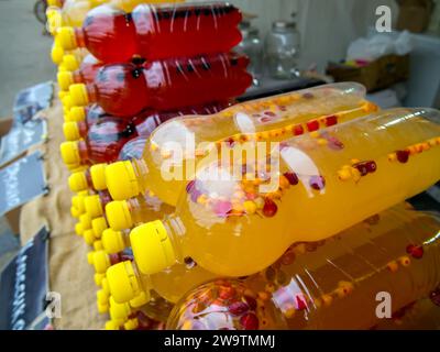 Homemade drinks based on fresh berries in plastic bottles Stock Photo